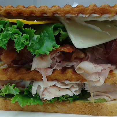 Club sandwich clubhouse sandwich on toasted bread sliced turkey bacon lettuce tomato mayonnaise